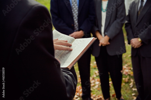 Church: Pastor Reading From Bible At Ceremony photo