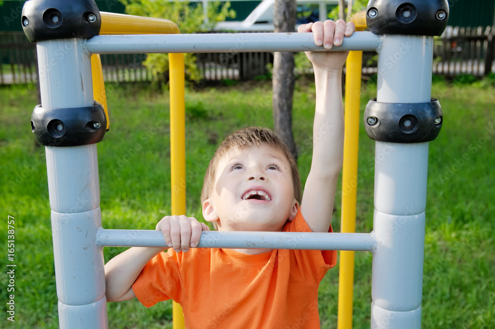 boy climbing stairs and playing outdoors on playground, children activity. Child having fun. Active healthy childhood concept boy climbing stairs and playing outdoors on playground, children activity. Child having fun. Active healthy childhood concept