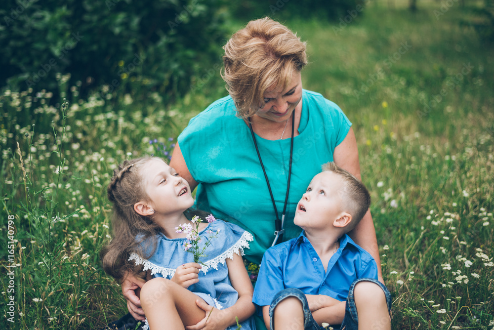 Grandmother playing in the park with grandchildren Grandmother playing in the park with grandchildren