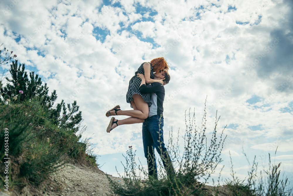 young man hold woman on the peak young man hold woman on the peak