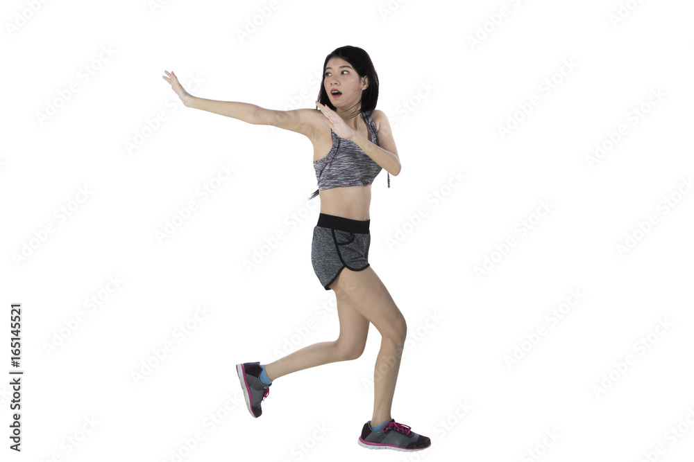 Scared slim woman running from something Scared slim woman running from something