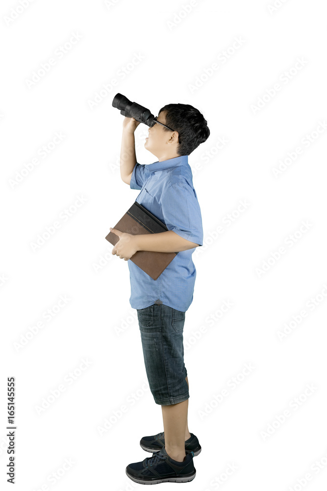 Schoolboy looking at something with a binocular Schoolboy looking at something with a binocular