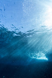 Rays of sunlight shining into sea, underwater view
