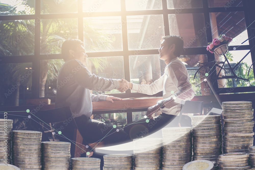 Double exposure of business handshake with stack of coins. arrow up and business graph. Business partner concept