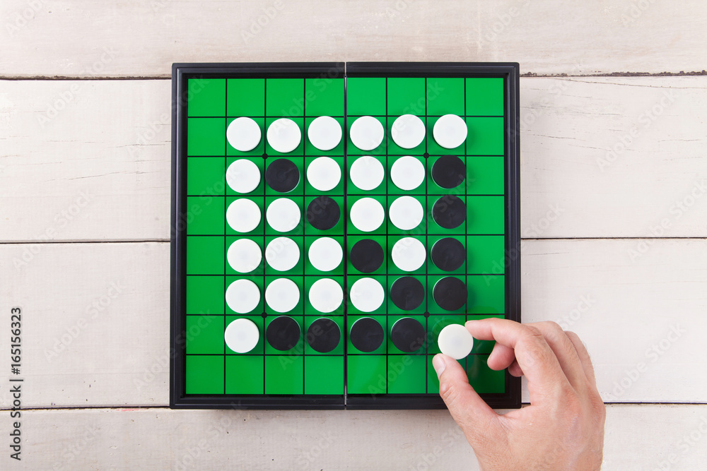 Go game on green board view from above on wood table. Go game on green board view from above on wood table.