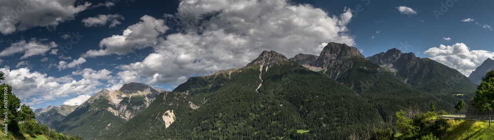 panoramic view of the lower Engadin valley with a mountain road near Sent and Scuol in Switzerland