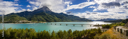 Panoramic view of Serre-Poncon Lake with Savines-le-Lac and its bridge with the Grand Morgon mountain peak in summer. Hautes-Alpes, Durance Valley, PACA Region, Southern French Alps, France photo
