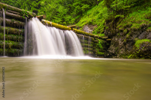 Beautiful typical waterfall on the river at the Kva  any mill in the mountains in Slovakia  