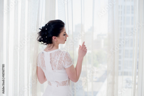 Free Download Beautiful bride standing near the window and looking away - GFXLoad