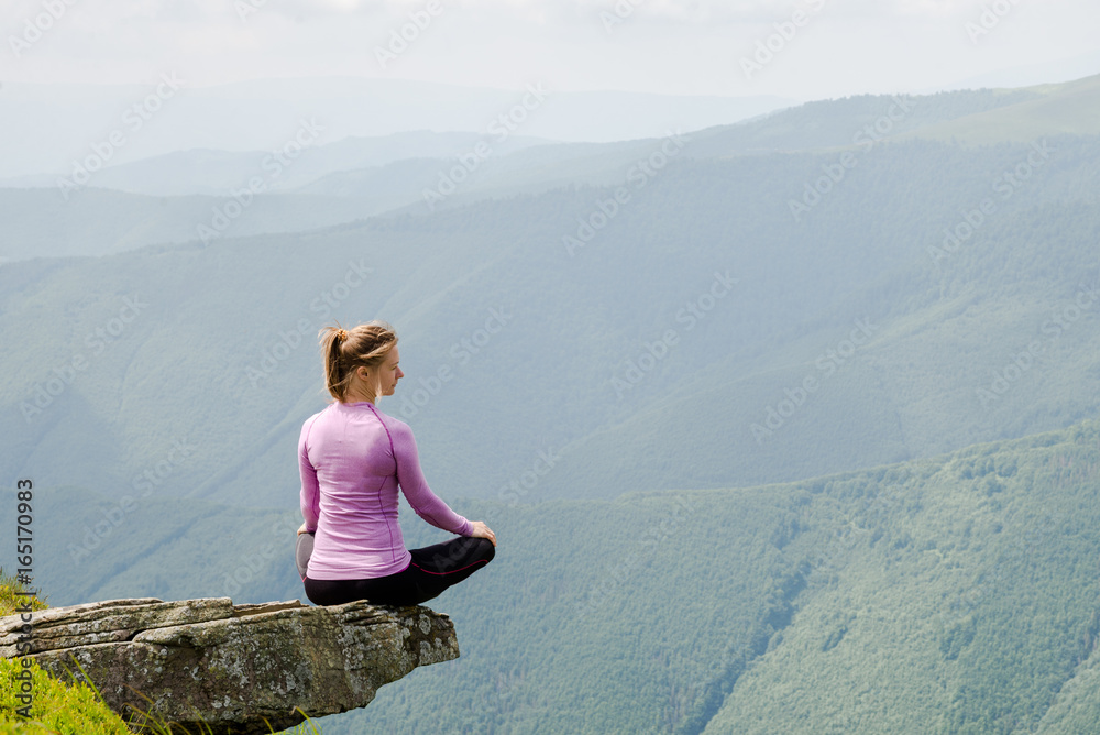Young woman sit on the top of mountains