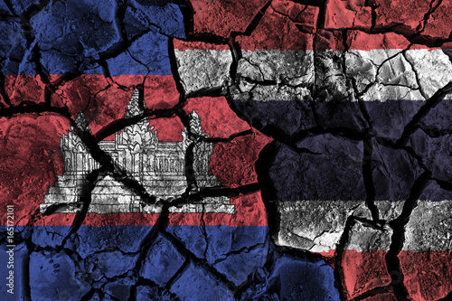 Cambodia and Thailand flag on cracked ground . Confliction and crisis concept photo