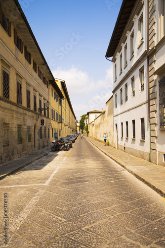 A picturesque and typical street of Florence with motorcycles and cars. © Ms VectorPlus