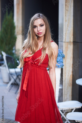 Beautiful blonde lady in red dress on White Square office center in Moscow, Russia © Alex Shadrin