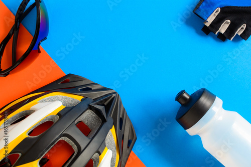 set bicycle equipment on a blue and orange paper background