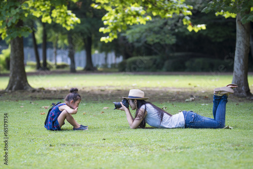 Mother taking pictures of her daughter