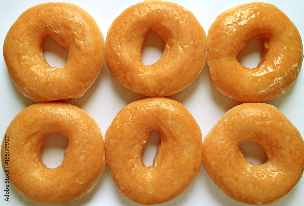Top view of six sugar-glazed doughnuts, for background and banner
