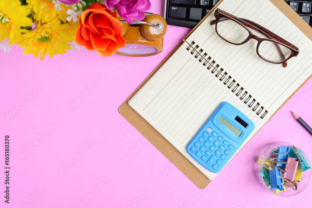 Flat lay office equipment on a pink paper desk