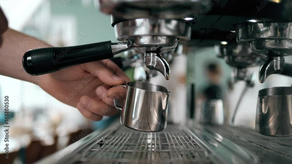 Prepares espresso in his coffee shop; close-up counter espresso automatic cappuccino bari sta portability coffee-shop coffee shop coffee mill coffee house coffee machine coffee dispenser