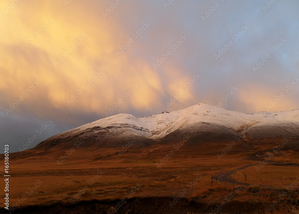 Sunset Cloudy Sky over the Snow Capped Mountain in Northern Iceland 