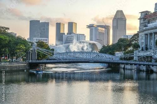 Cavenagh bridge over Singapore river at sunset, with skycreapers in background