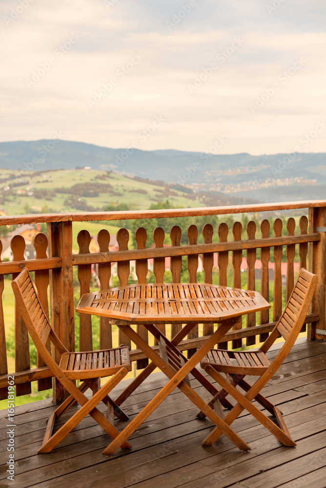  Set of furniture table and chairs wooden with a view of the mountains in a cafe