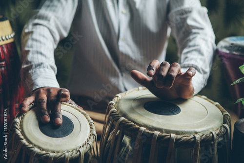 Indian man playing traditional indian drums photo