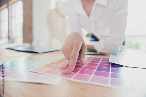 Creative occupation. Close up hand of female graphic designer, interior designer, architect, stylist, she is choosing the colors for new project photo