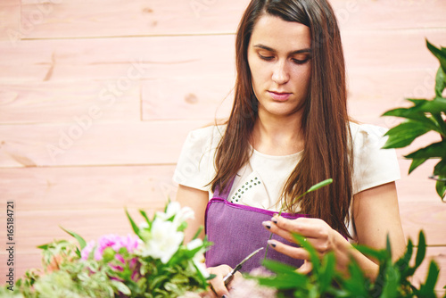 Girl florist creates a bouquet of flowers in the Studio photo