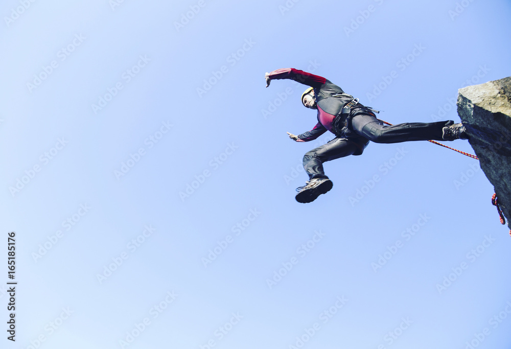 Jump off a cliff into a canyon with a rope. Jump off a cliff into a canyon with a rope.