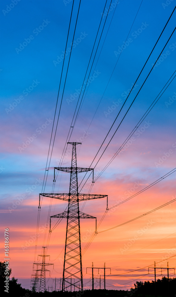 silhouette engineer repair and electrical installation work on high voltage pylons over.