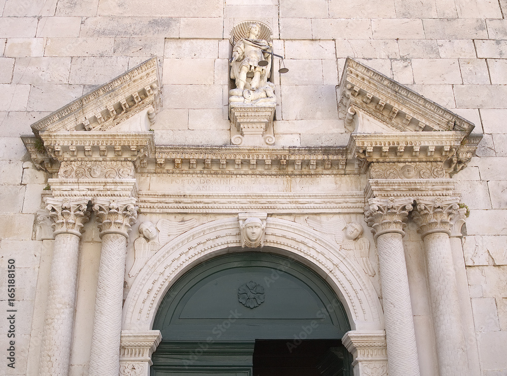 Obraz premium Detail of the church entrance door, Facade of old church in Omis, Dalmatia, Croatia