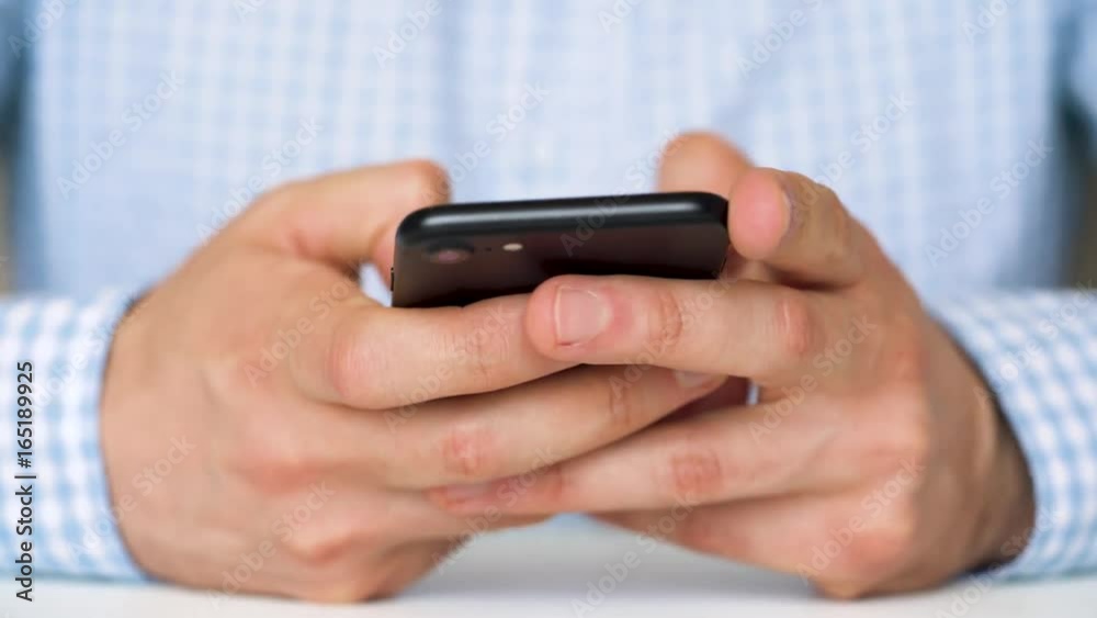 Businessman using smartphone for text messaging Businessman using smartphone for text messaging