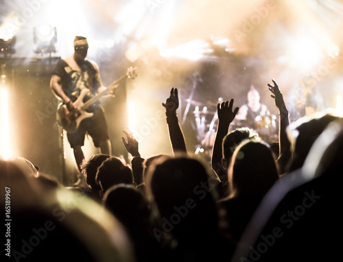 crowd with raised hands at concert - summer music festival