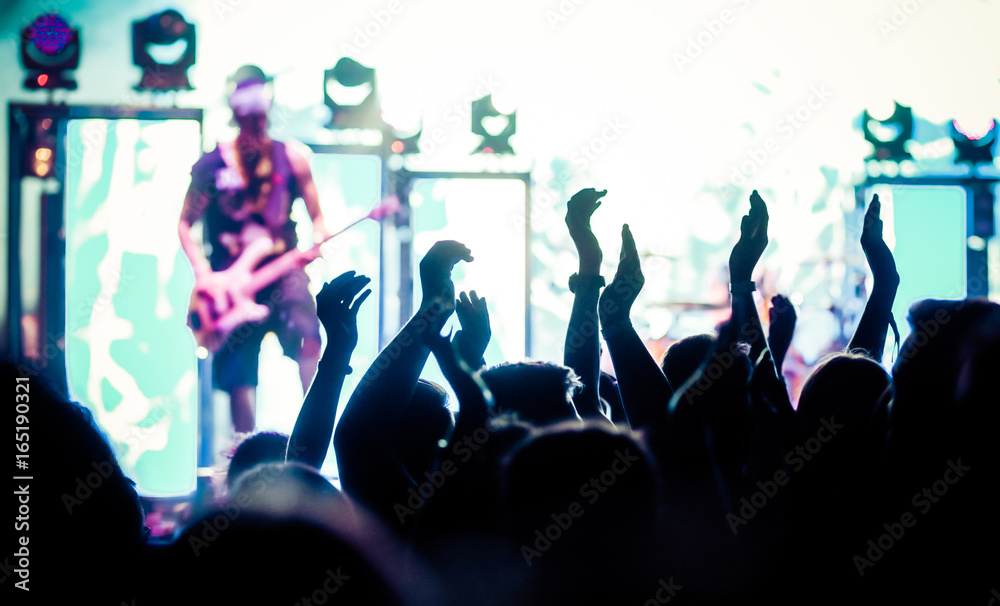 crowd with raised hands at concert - summer music festival