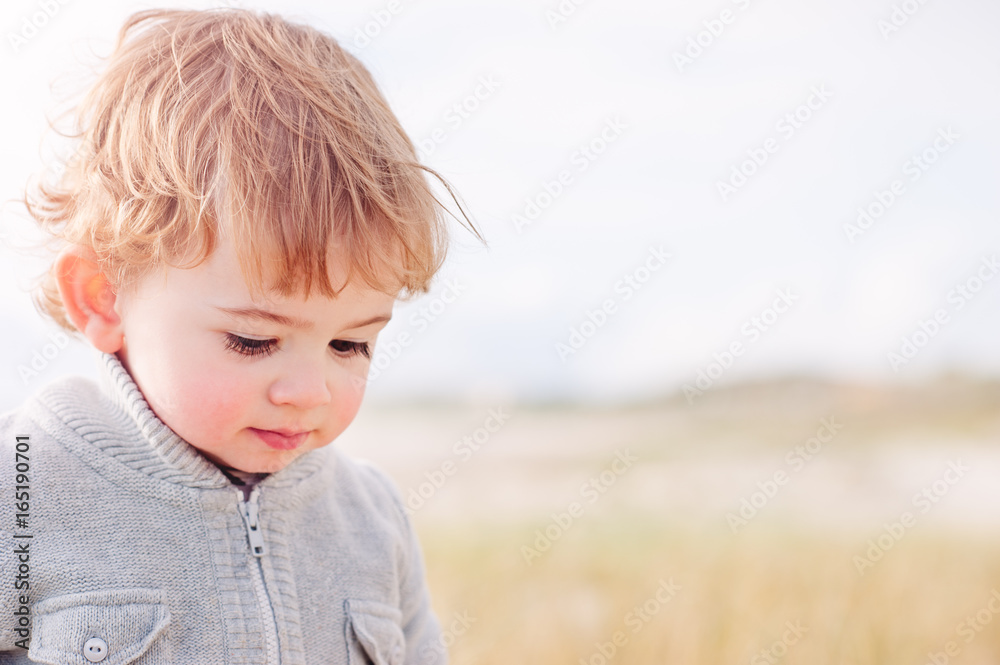 Toddler at the beach in winter Toddler at the beach in winter