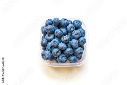 Glass bowl with blueberries on white background top view