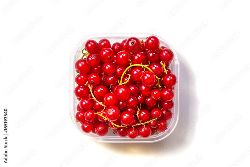 Redcurrant in a glass bowl on a white background Redcurrant in a glass bowl on a white background