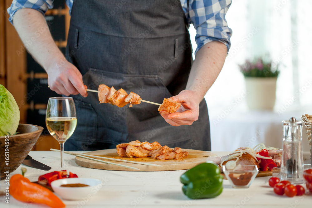 male preparing chicken for cooking