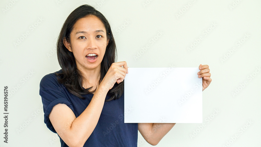 Casual Asian woman holding white sign with copy space Casual Asian woman holding white sign with copy space