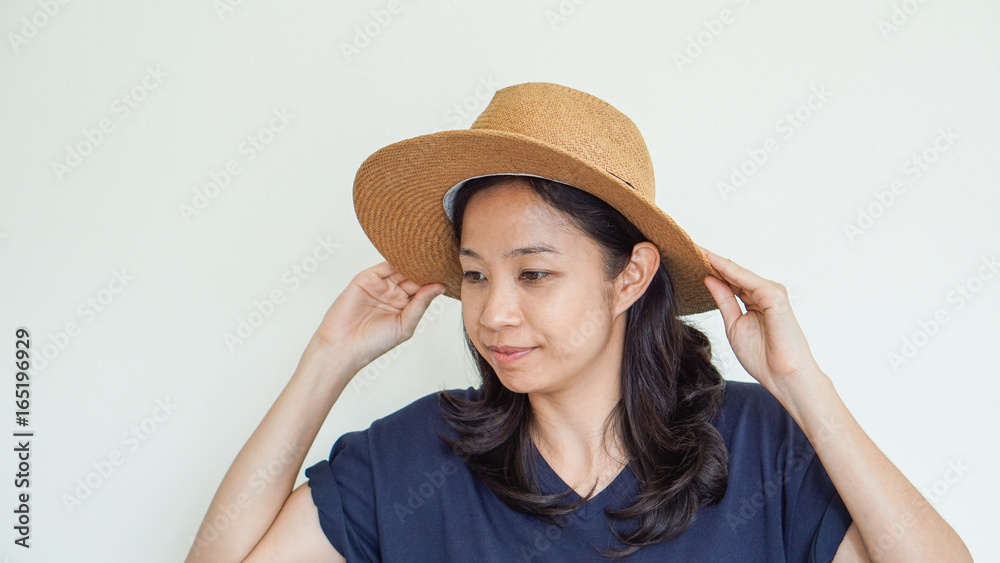 Asian girl wearing straw hat summer fun. Relax and happy expression Asian girl wearing straw hat summer fun. Relax and happy expression