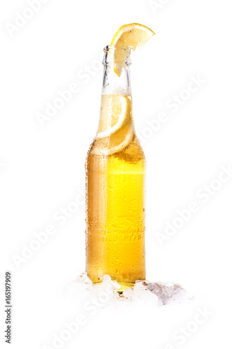 Front view of a bottle of blonde beer with lemon inside and white background