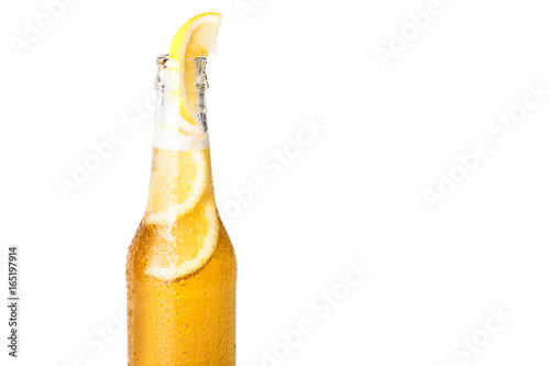 Front view of a bottle of blonde beer with lemon inside and white background