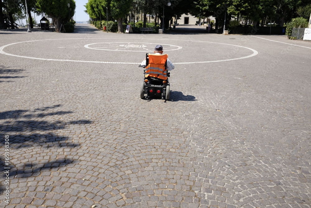 Senior on electric wheelchair in park Senior on electric wheelchair in park