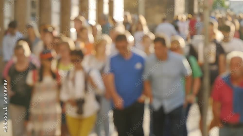 People walking down the street in the evening. Defocus and slow motion People walking down the street in the evening. Defocus and slow motion