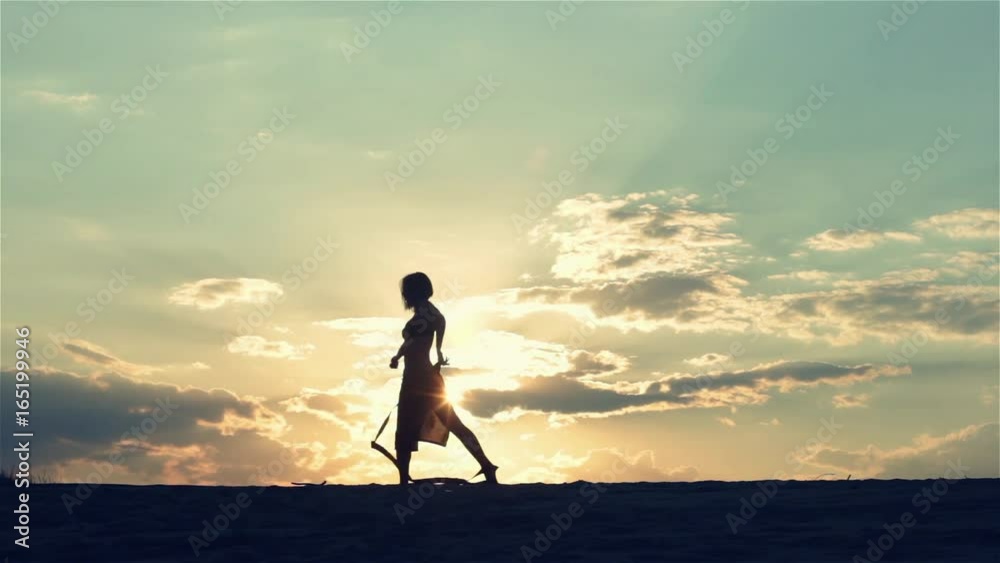 Silhouette of a dancing woman at sunset Silhouette of a dancing woman at sunset