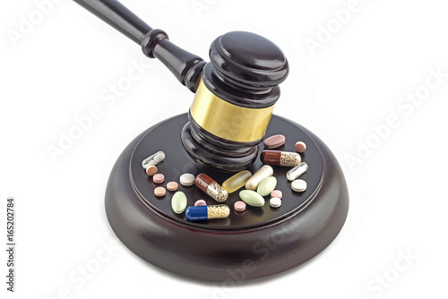 judge gavel and various drugs, tablets and pills isolated on a white background, justice and medicine concept