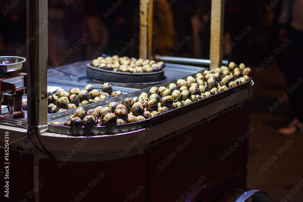 Street Vendor Roasted Chestnuts lit in the Night.