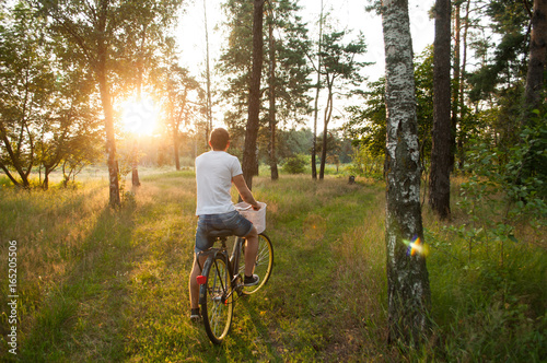the guy on the bike in the Park, cyclist at sunset, © vulkanov