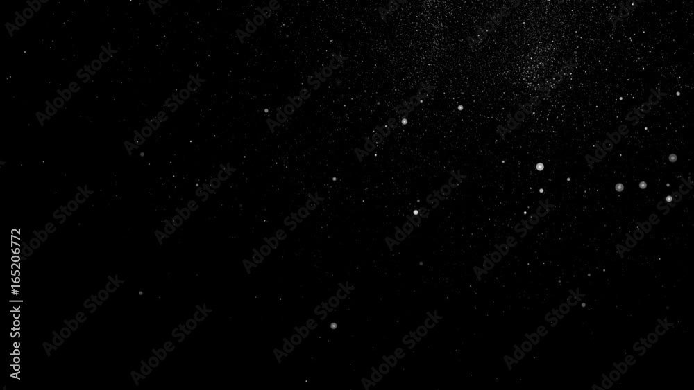 White particles and ink slowly moving in water on black background White particles and ink slowly moving in water on black background