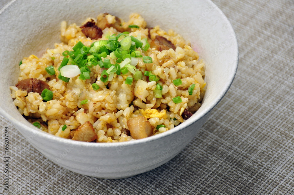 Close-up fried rice with garlic and deep fried pork in bowl Japanese style Close-up fried rice with garlic and deep fried pork in bowl Japanese style